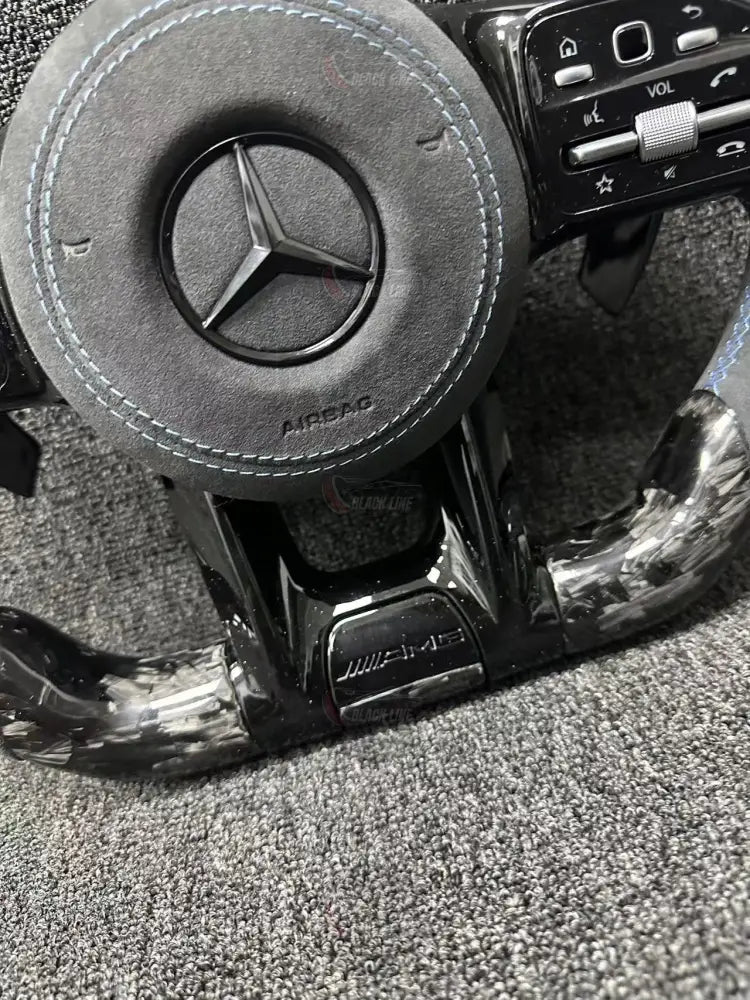 Volante Deportivo Mercedes-AMG de Carbono Forjado y Alcántara con Costura Azul Levas y Airbag Incluido